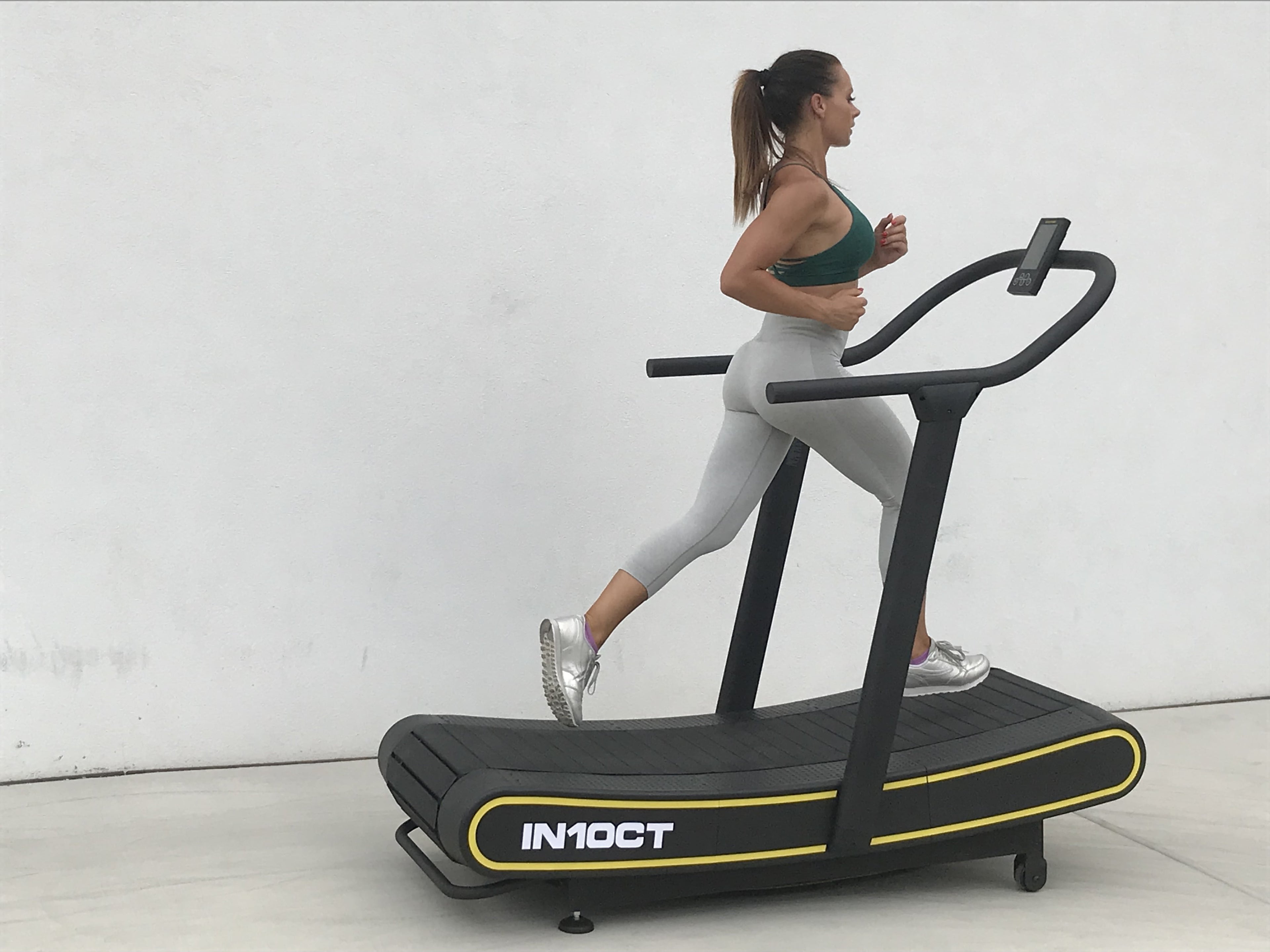 Sleek Black and Yellow Manual Curved Treadmill for Ultimate Home Workouts