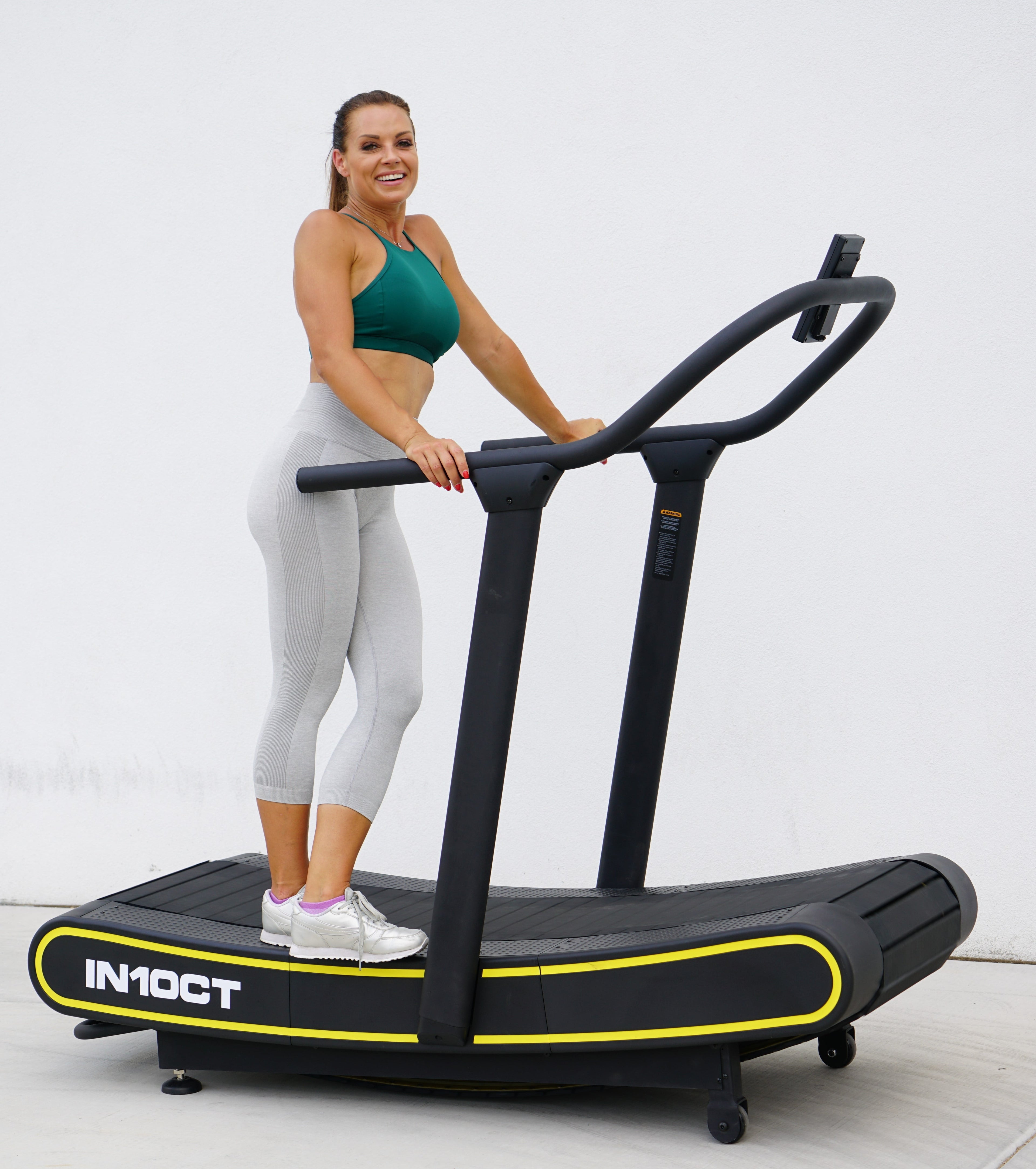 Sleek Black and Yellow Manual Curved Treadmill for Ultimate Home Workouts