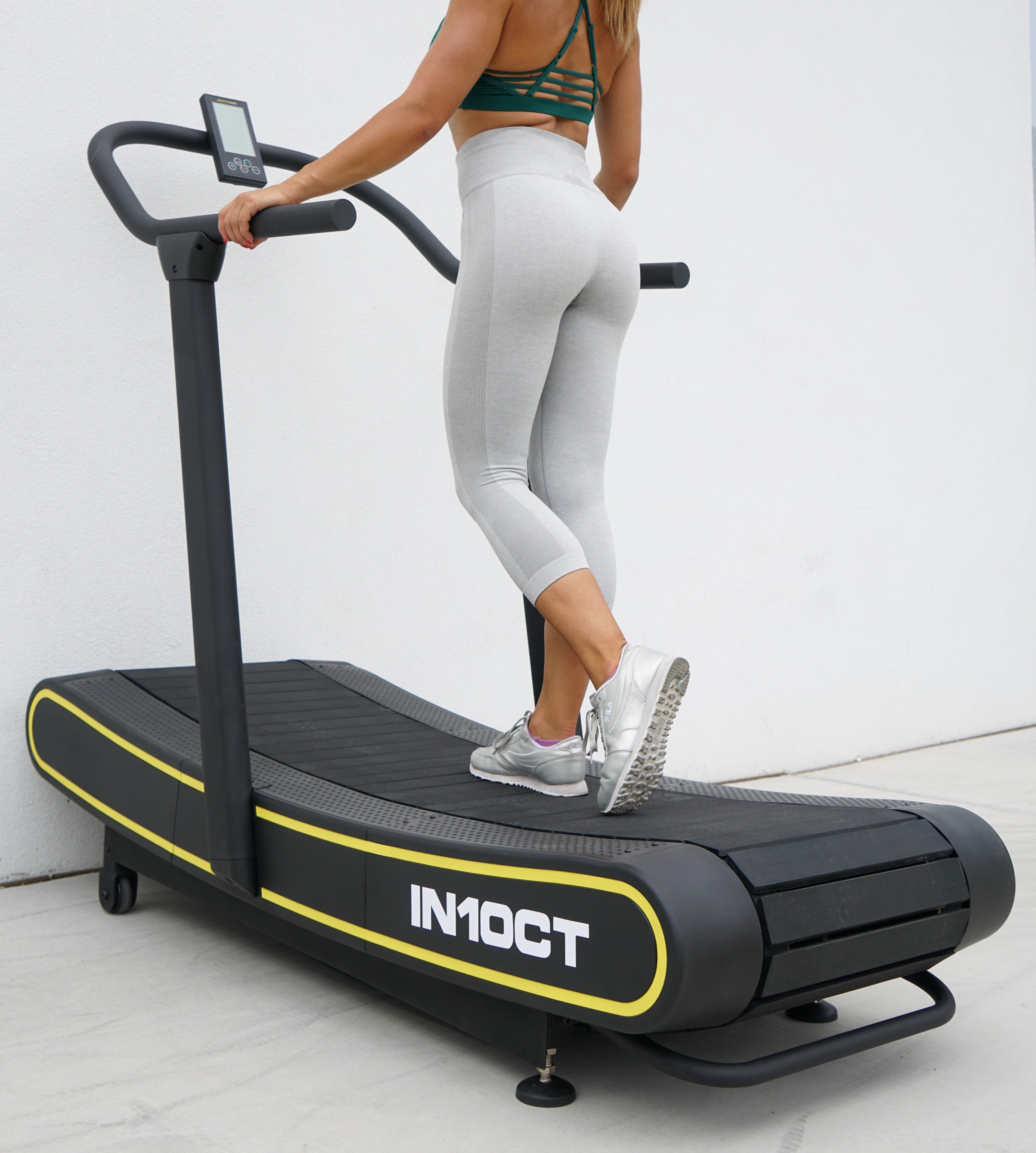 Sleek Black and Yellow Manual Curved Treadmill for Ultimate Home Workouts
